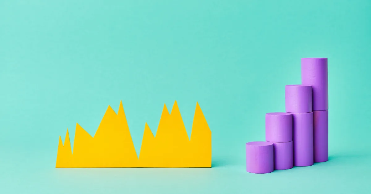 A jagged yellow paper-cut line chart beside a rising bar chart built from purple wooden cylinders on a teal background