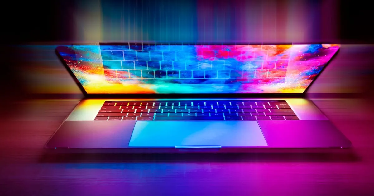 Half-open laptop with vivid colors glowing from the screen